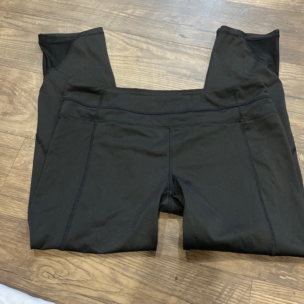 Plain black leggings with mesh at the bottoms cropped and mid rise